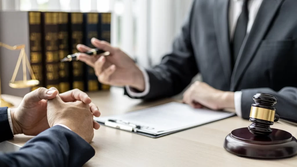 a personal injury attorney sitting at a table holding a pen and a case checklist