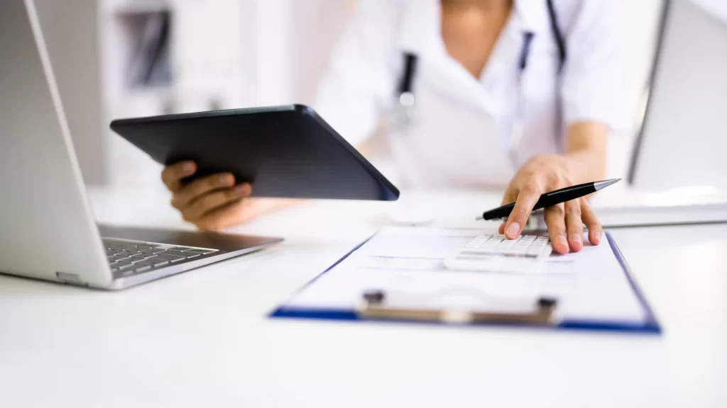 a doctor using a tablet and a keyboard
