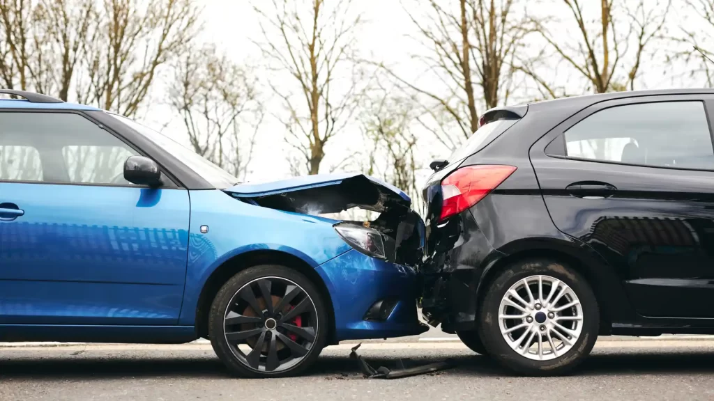 a blue car with a broken front end