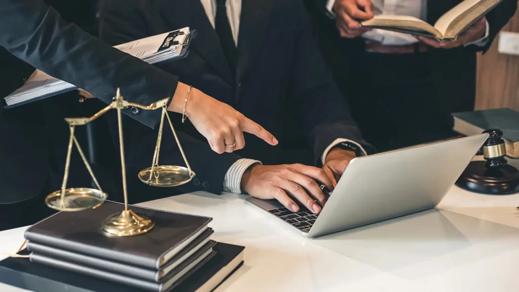 a personal injury lawyer pointing at a laptop